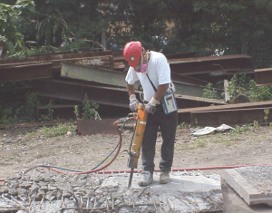 Photo of a jackhammer in use here has a water-spray attachment to control dust. Credit: NIOSH