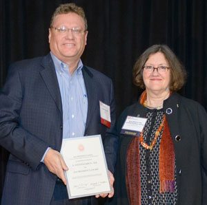 AIA Pennsylvania honors architect for work with Department of Environmental Protection. Steve Krug accepts President's Award from Betsy Masters.