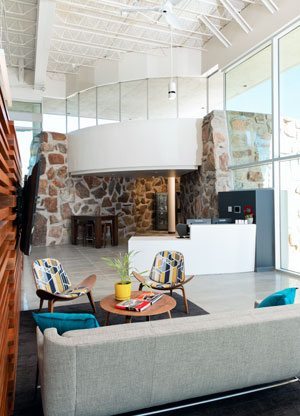 Lounge area with stone-walled vault in the background.  Photo by CAPSPHOTO International