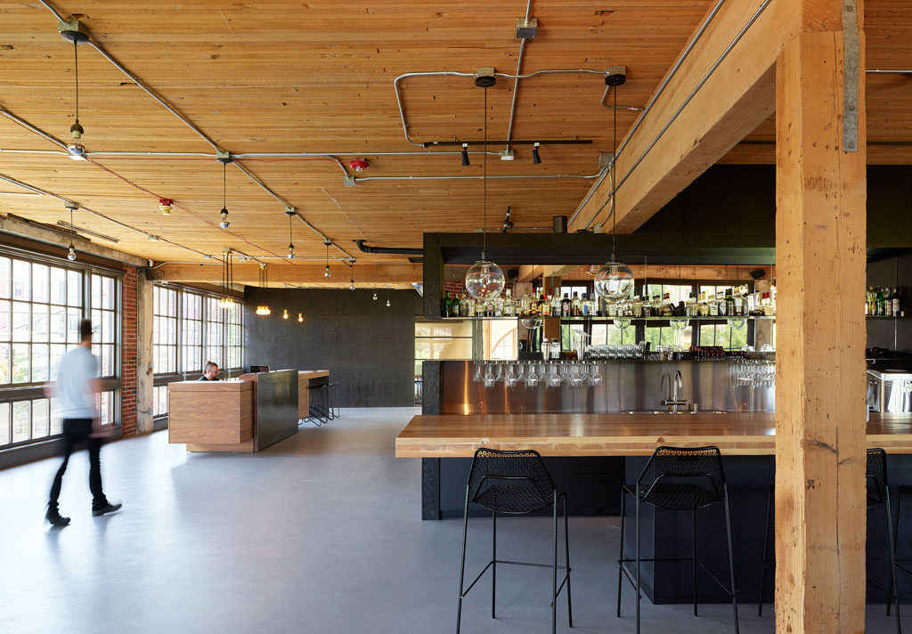 Bar and kitchen with large cross-laminated timber countertops. Photo by Kevin Scott