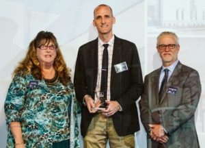 KAI Director of Design-Build Marcus Moomey (center) receives the DBIA-MAR 2018 Honor Award on behalf of the design-build team on the Deaconess Center for Child Well-Being project.