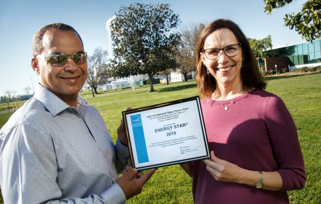 Vitro Architectural Glass employees Glen Collins, Fresno plant supervisor (left), and Wendy Garcia, environmental manager, receive an ENERGY STAR-labeled plant certificate for the company’s Fresno, California plant. The float line at Fresno was redesigned and rebuilt in 2016 to incorporate the latest advances in insulating refractory materials. The plant produces clear, Acuity low-iron and Starphire Ultra-Clear low-iron glasses.