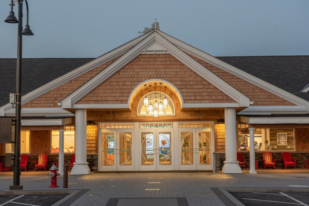 The exterior design of the Long Island Welcome Center was inspired by Long Island’s historic grand estates. The design incorporates a shingle-style portico entrance with arched openings framing an ornamental window, expansive doors, and a large welcoming porch. Courtesy of Stantec