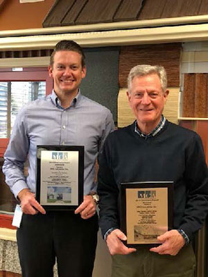 Justin Epler (left), PPG director, coil and building products, and Scott Moffatt, PPG architectural manager, coil and building products, industrial coatings, hold the two Chairman’s Awards presented to PPG at Metal Construction Association’s 2020 Winter Meeting.