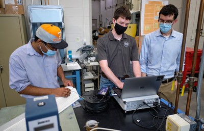 From left, Dr. Dayakar Penumadu’ s research group member Dr. Stephen Young, and graduate students Andrew Patchen and Joey Michaud are part of the University of Tennessee’s team working to equip the fiber reinforced polymer bridge deck with high-density fiber optic and fiber Bragg grating sensors to monitor long-term durability. 