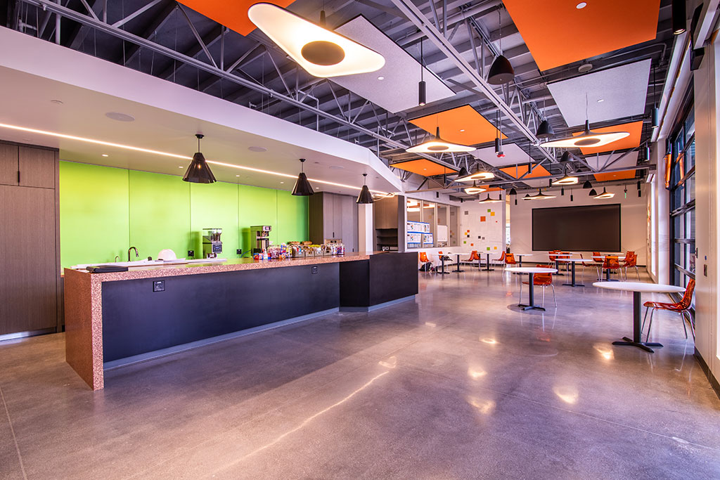 MBC BioLabs at 930 Brittan Avenue’s bright, vibrant cafe and lounge, where visitors and employees are welcomed to mingle. Photo courtesy of MBH Architects