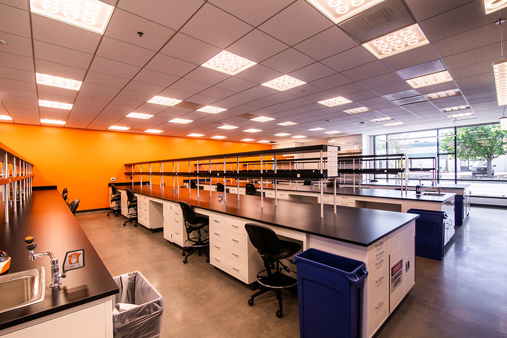 Unlike most lab environments, MBC BioLabs at 930 Brittan Avenue is inclusive of cheerful color schemes of green and orange, paying homage to the MBC logo. Photo courtesy of MBH Architects