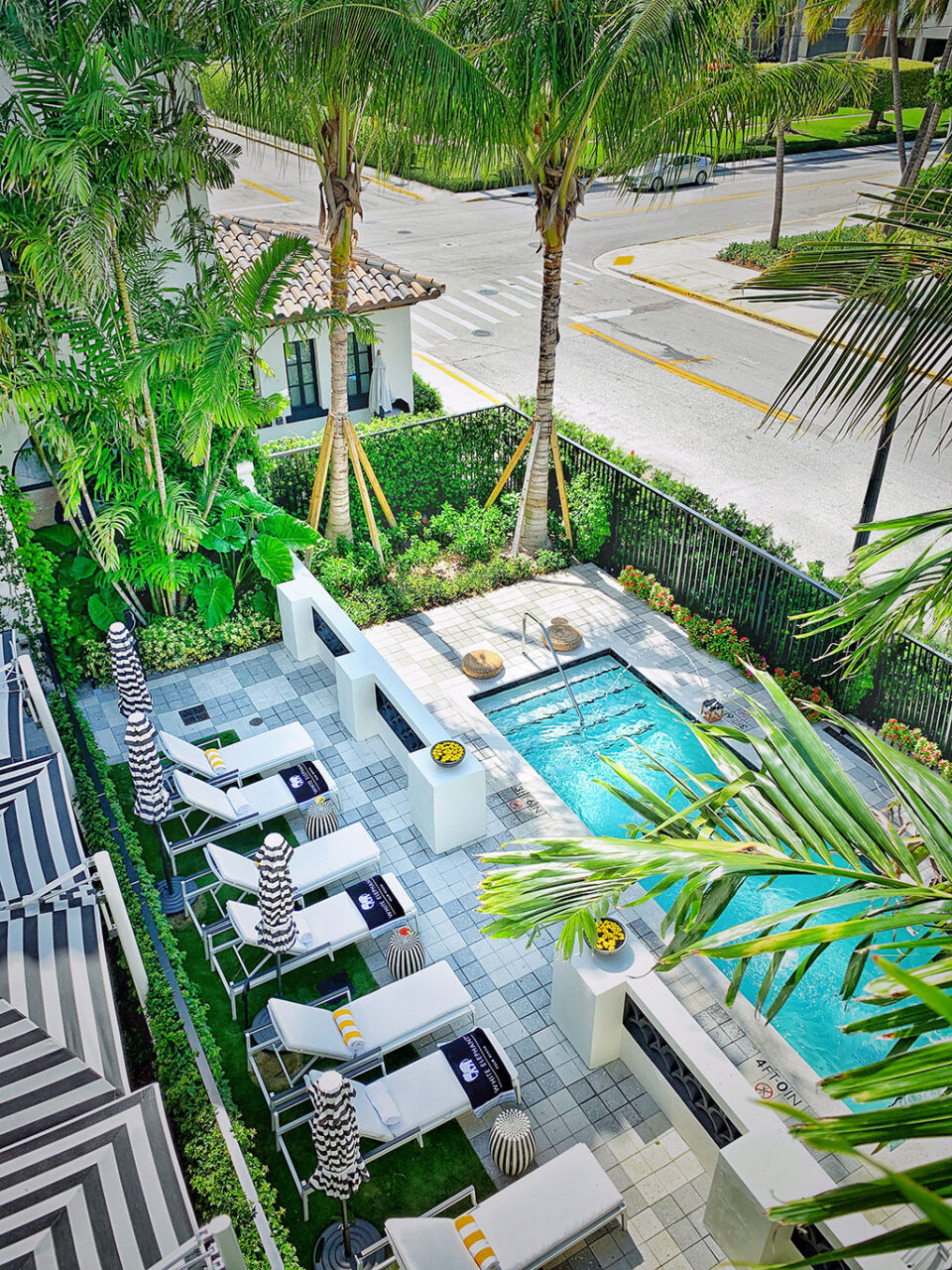 In order to preserve the original low wing walls that were the front boundary of the hotel, the central courtyard was enlarged to extend beyond its original footprint with a new outdoor pool located at the front of the hotel. Designers added to the original landscaping, making the courtyard greener and more lush and activating it with poolside lounging and outdoor dining. Photo Credit: © Chi-Thien Nguyen/Elkus Manfredi Architects